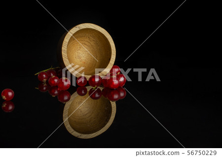 Fresh red currant isolated on black glass Fresh red currant isolated on black glass 56750229