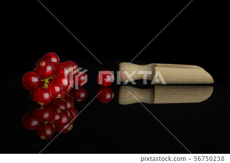 Fresh red currant isolated on black glass Fresh red currant isolated on black glass 56750238