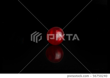Fresh red currant isolated on black glass Fresh red currant isolated on black glass 56750240