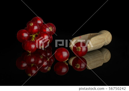 Fresh red currant isolated on black glass Fresh red currant isolated on black glass 56750242