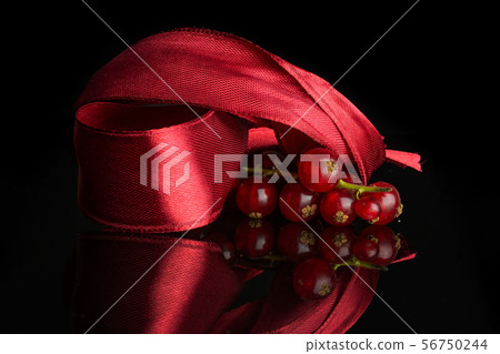 Fresh red currant isolated on black glass Fresh red currant isolated on black glass 56750244