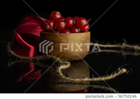 Fresh red currant isolated on black glass Fresh red currant isolated on black glass 56750246