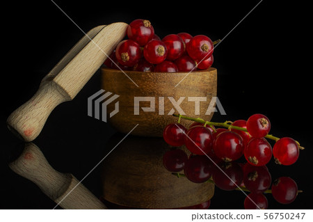 Fresh red currant isolated on black glass Fresh red currant isolated on black glass 56750247
