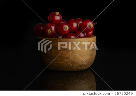 Fresh red currant isolated on black glass 56750249