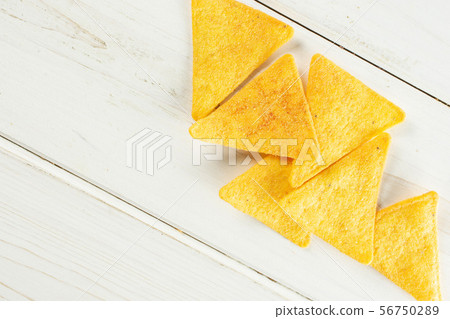 Tortilla cheese chips on grey wood Tortilla cheese chips on grey wood 56750289