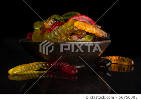Jelly worm candy isolated on black glass 56750395