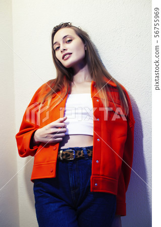 young pretty teenage hipster girl posing emotional happy smiling on white background, lifestyle 56755969