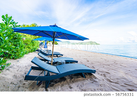 Beautiful umbrella and empty bed chair on the tropical beach and sea with white cloud blue sky background 56756331