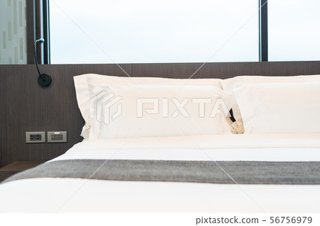 Beautiful luxury comfortable white pillow and blanket on bed with light lamp 56756979
