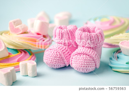 pair of small baby socks on blue background with 56759363