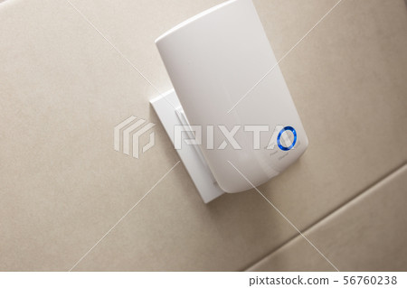 Wifi home repeater plugged in closeup. 56760238