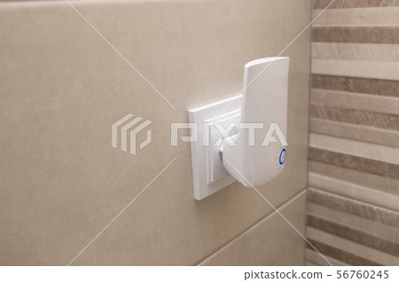 Wifi home repeater plugged in closeup. Wifi home repeater plugged in closeup. 56760245