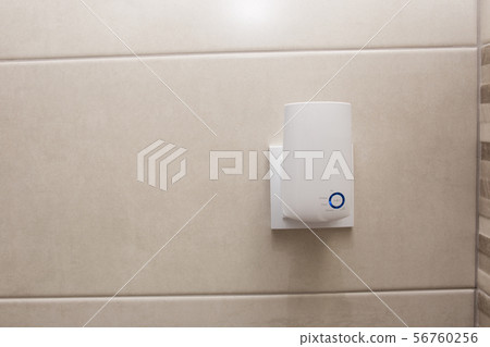 Wifi home repeater plugged in closeup. 56760256