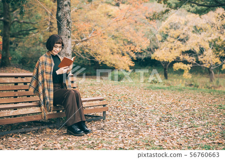 A woman reading in the park A woman reading in the park 56760663