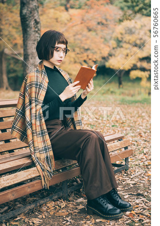 A woman reading in the park A woman reading in the park 56760665