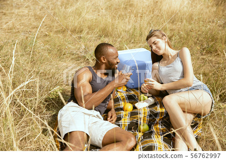Young multiethnic international couple outdoors Young multiethnic international couple outdoors 56762997