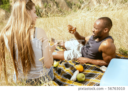 Young multiethnic international couple outdoors Young multiethnic international couple outdoors 56763010