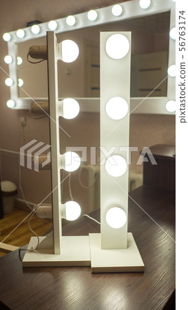 Demonstration of light bulbs for make-up mirrors. 56763174