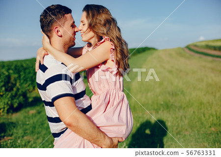 Beautiful couple spend time on a summer field 56763331