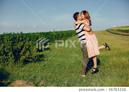 Beautiful couple spend time on a summer field 56763338