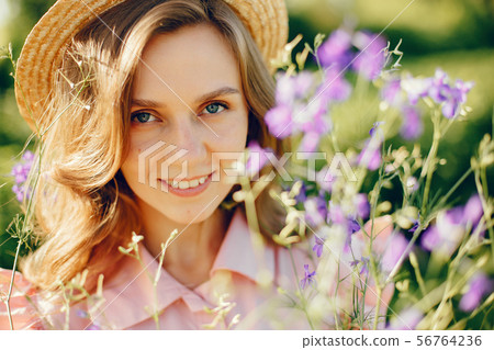 Elegant and stylish girl in a summer field Elegant and stylish girl in a summer field 56764236