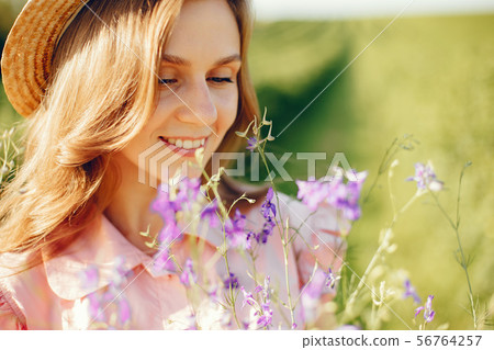 Elegant and stylish girl in a summer field Elegant and stylish girl in a summer field 56764257