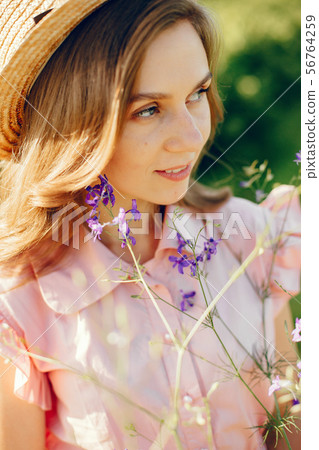 Elegant and stylish girl in a summer field 56764259