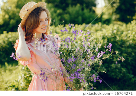Elegant and stylish girl in a summer field 56764271