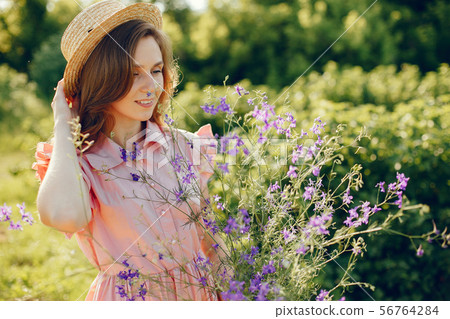 Elegant and stylish girl in a summer field Elegant and stylish girl in a summer field 56764284