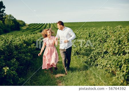 Beautiful couple spend time on a summer field 56764392