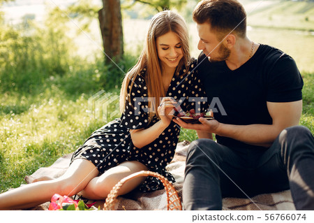 Beautiful couple spend time in a summer field 56766074