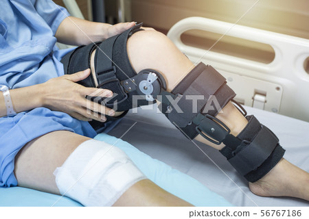 Asian woman patient with bandage compression knee 56767186