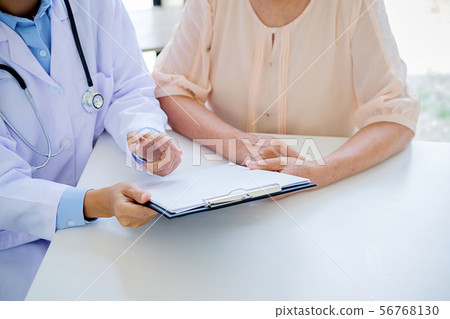 Patient listening intently to a male doctor Patient listening intently to a male doctor 56768130