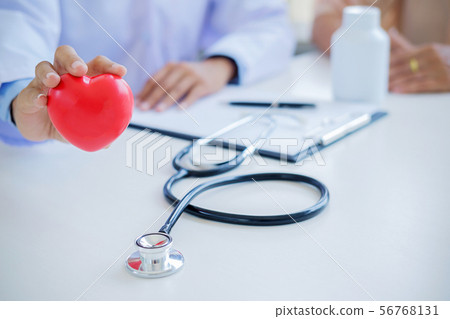 Doctor with stethoscope holding heart. Doctor and Doctor with stethoscope holding heart. Doctor and 56768131