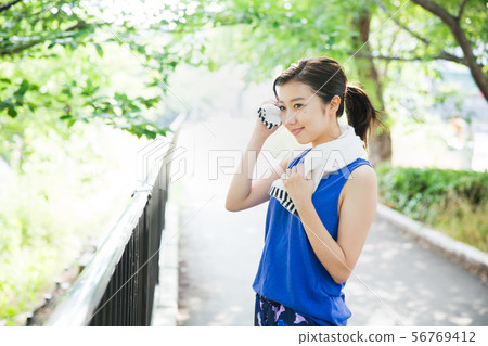 Young woman running in the green 56769412