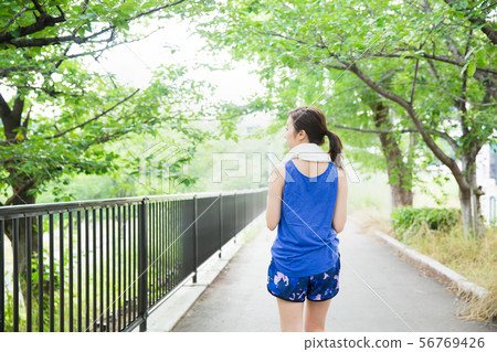 Young woman running in the green Young woman running in the green 56769426