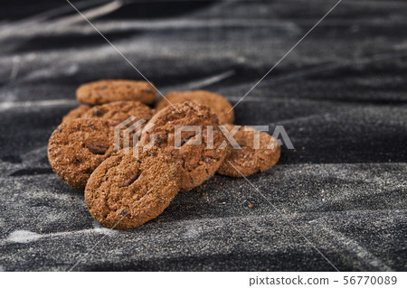 Double chocolate chip fresh cookies heap on black Double chocolate chip fresh cookies heap on black 56770089