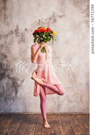 Pretty yoga girl stands in beautiful asana indoors Pretty yoga girl stands in beautiful asana indoors 56771399