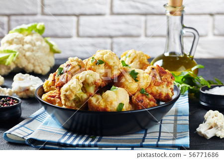Cauliflower florets fried in batter, top view Cauliflower florets fried in batter, top view 56771686