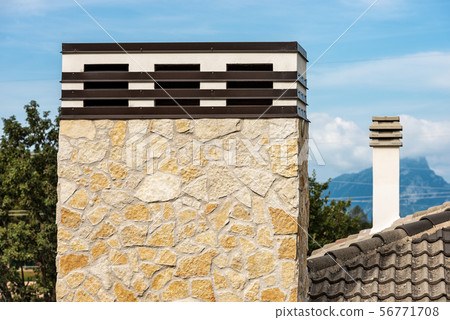Two chimneys on the roof of a residential house Two chimneys on the roof of a residential house 56771708