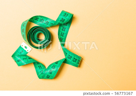 Top view of measure tape curtailed into a spiral Top view of measure tape curtailed into a spiral 56773167