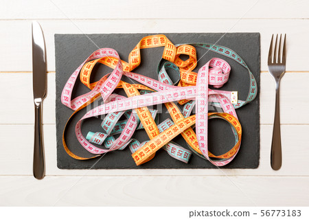 Top view of heap of colorful measuring tapes in 56773183