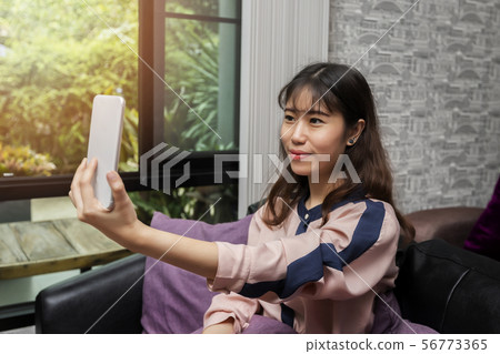 Asian businesswoman taking selfie photo. Asian businesswoman taking selfie photo. 56773365