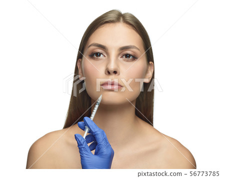 Portrait of beautiful young woman isolated on white studio background 56773785