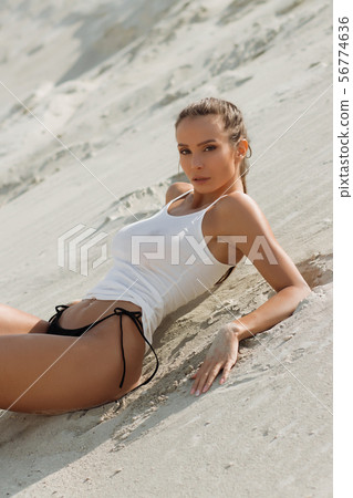 Beautiful sexy female relaxing on sandy beach 56774636