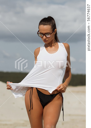 Pretty female in beachwear on nature background Pretty female in beachwear on nature background 56774637