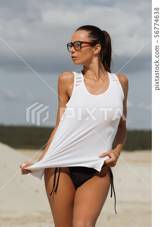 Pretty female in beachwear on nature background Pretty female in beachwear on nature background 56774638
