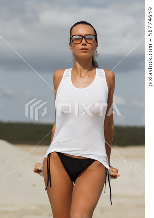 Pretty female in beachwear on nature background Pretty female in beachwear on nature background 56774639