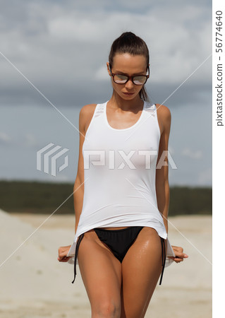 Pretty female in beachwear on nature background Pretty female in beachwear on nature background 56774640