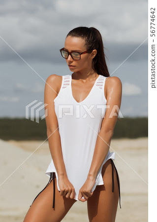 Pretty female in beachwear on nature background 56774642